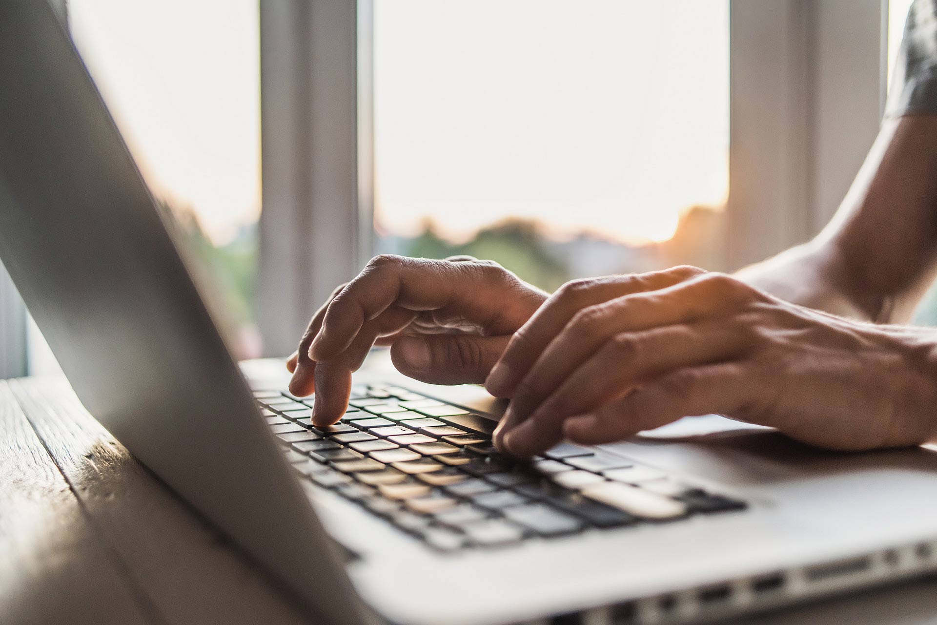 Image of a person typing on a laptop