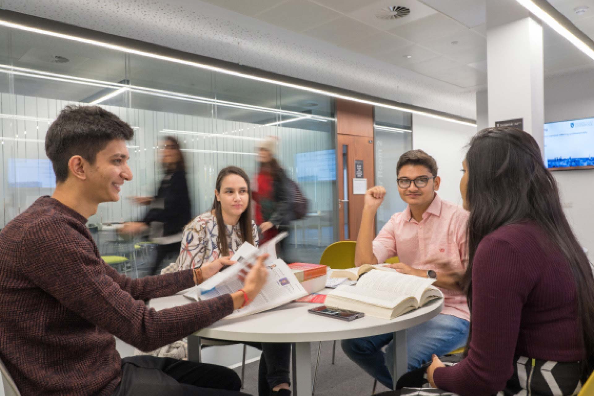 Postgraduate research students in a group discussing work