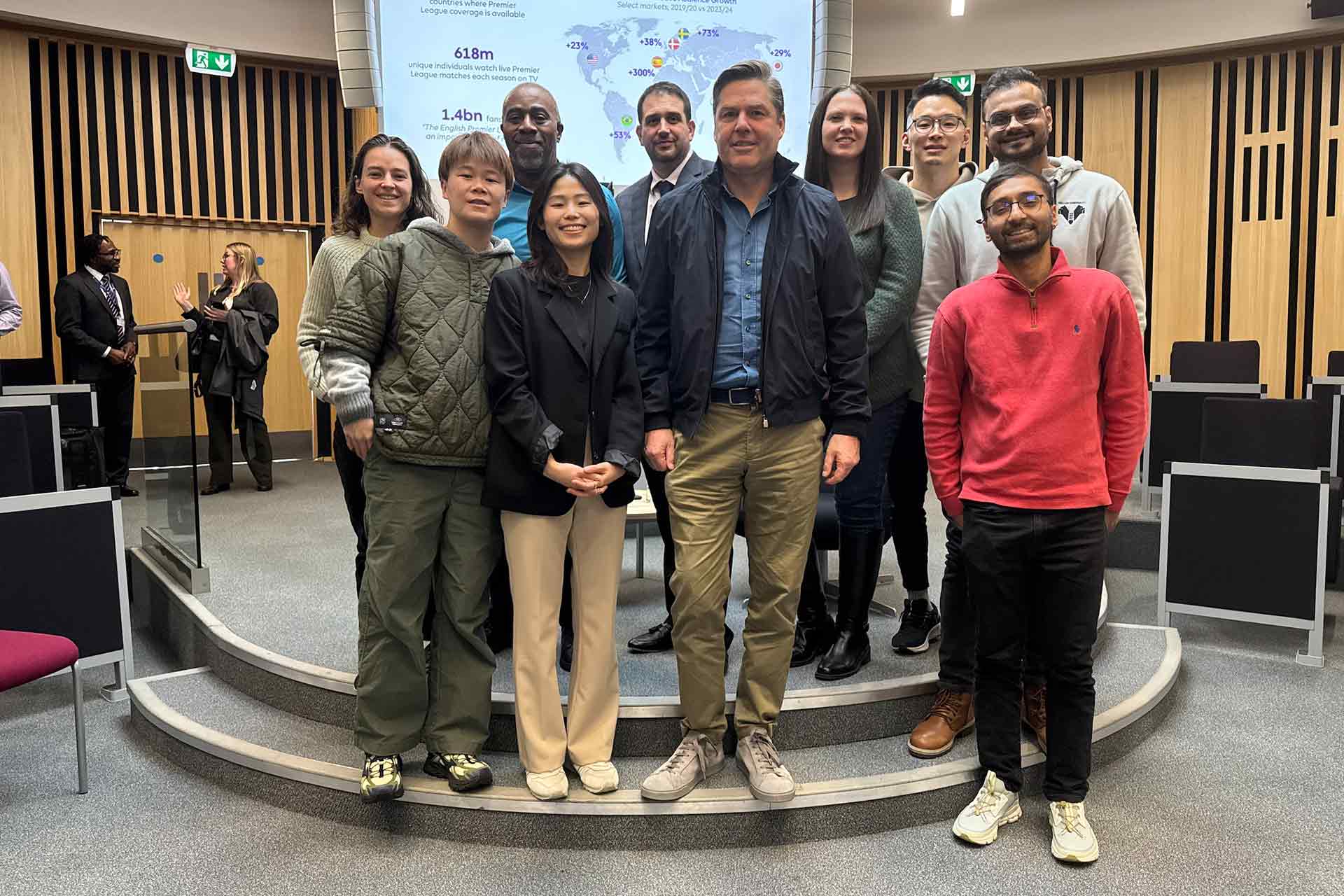 MBA guest speaker Richard Masters takes a picture with MBA students in Brett drum