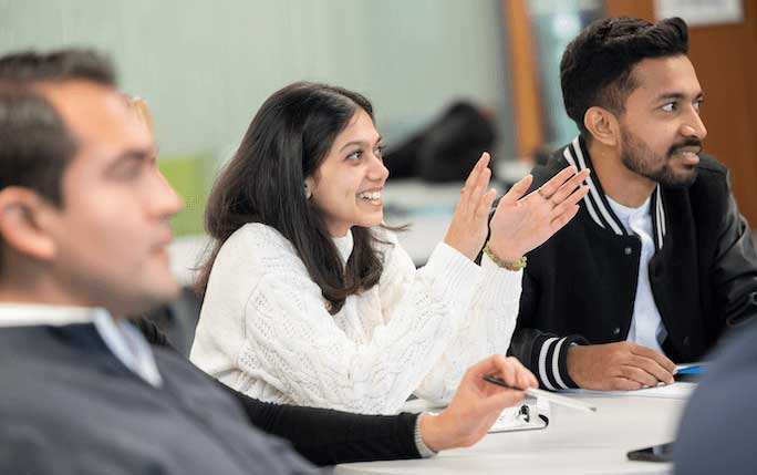 Master's students taking part in a discussion