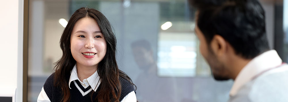 Two postgraduate students working on a group project