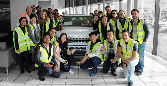 Students standing in a group on a visit to a local organisation