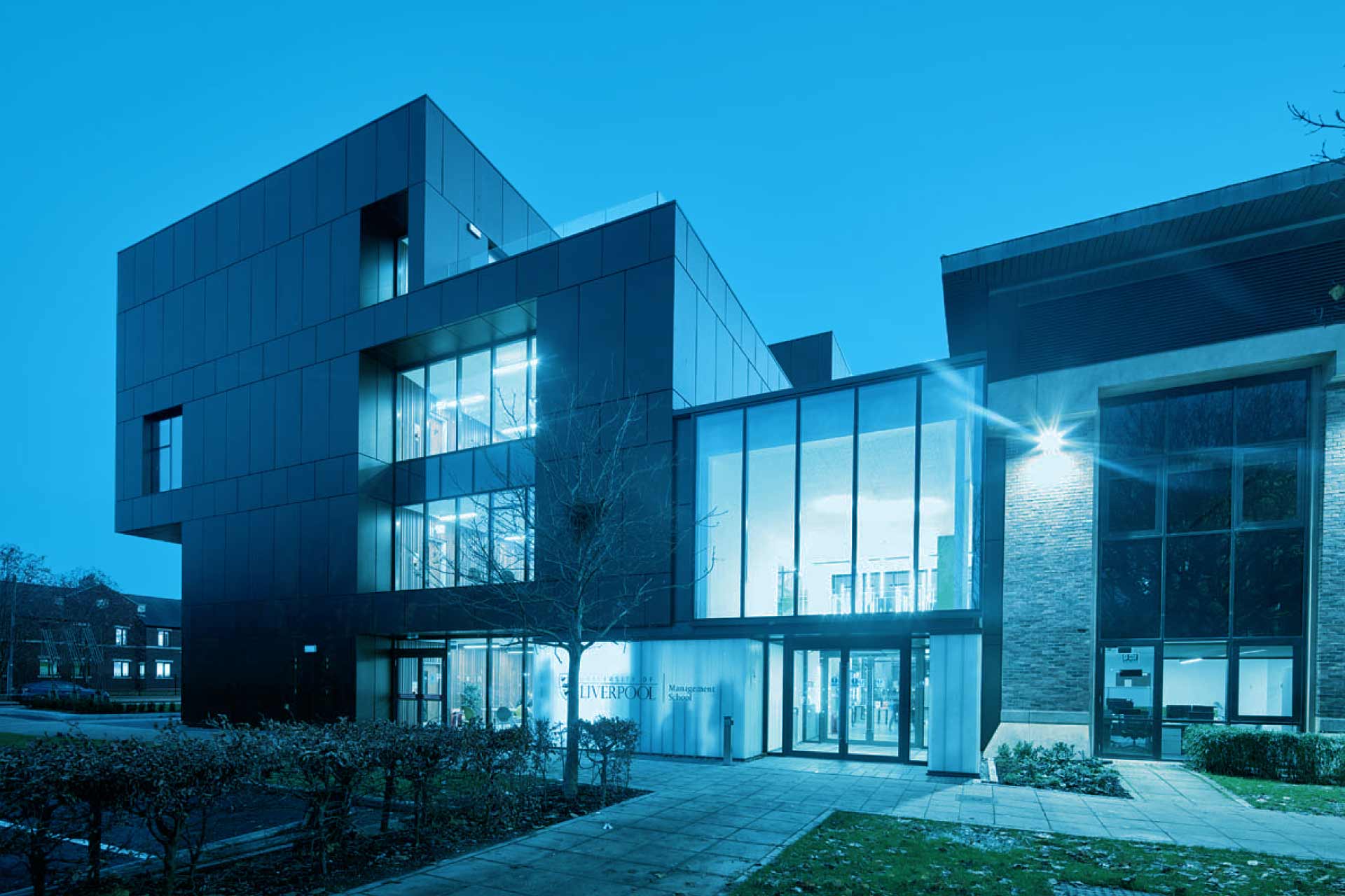 Night image of University of Liverpool Management School tinted in blue