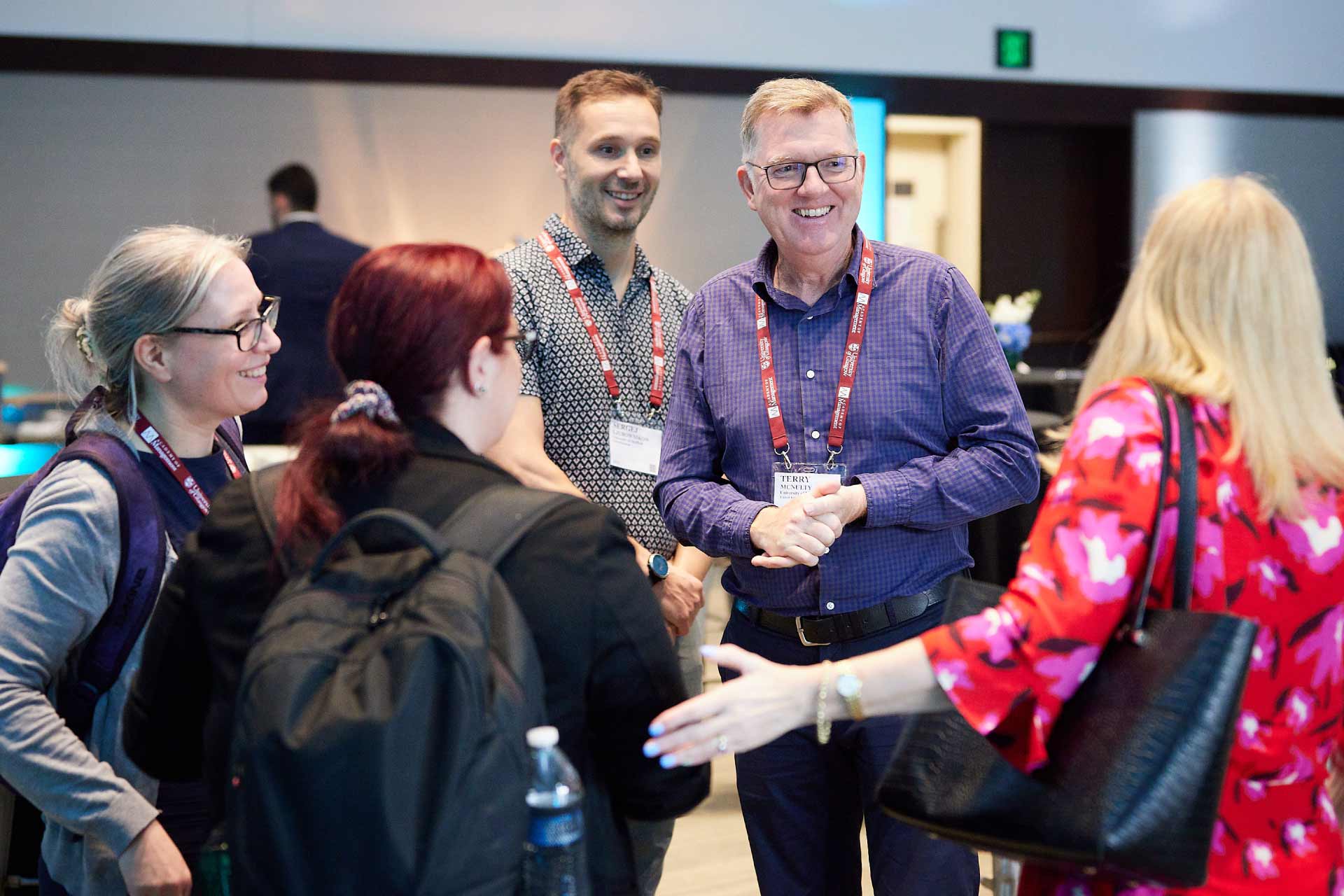 Academics greeting each other at the AOM 23 University of Liverpool reception.