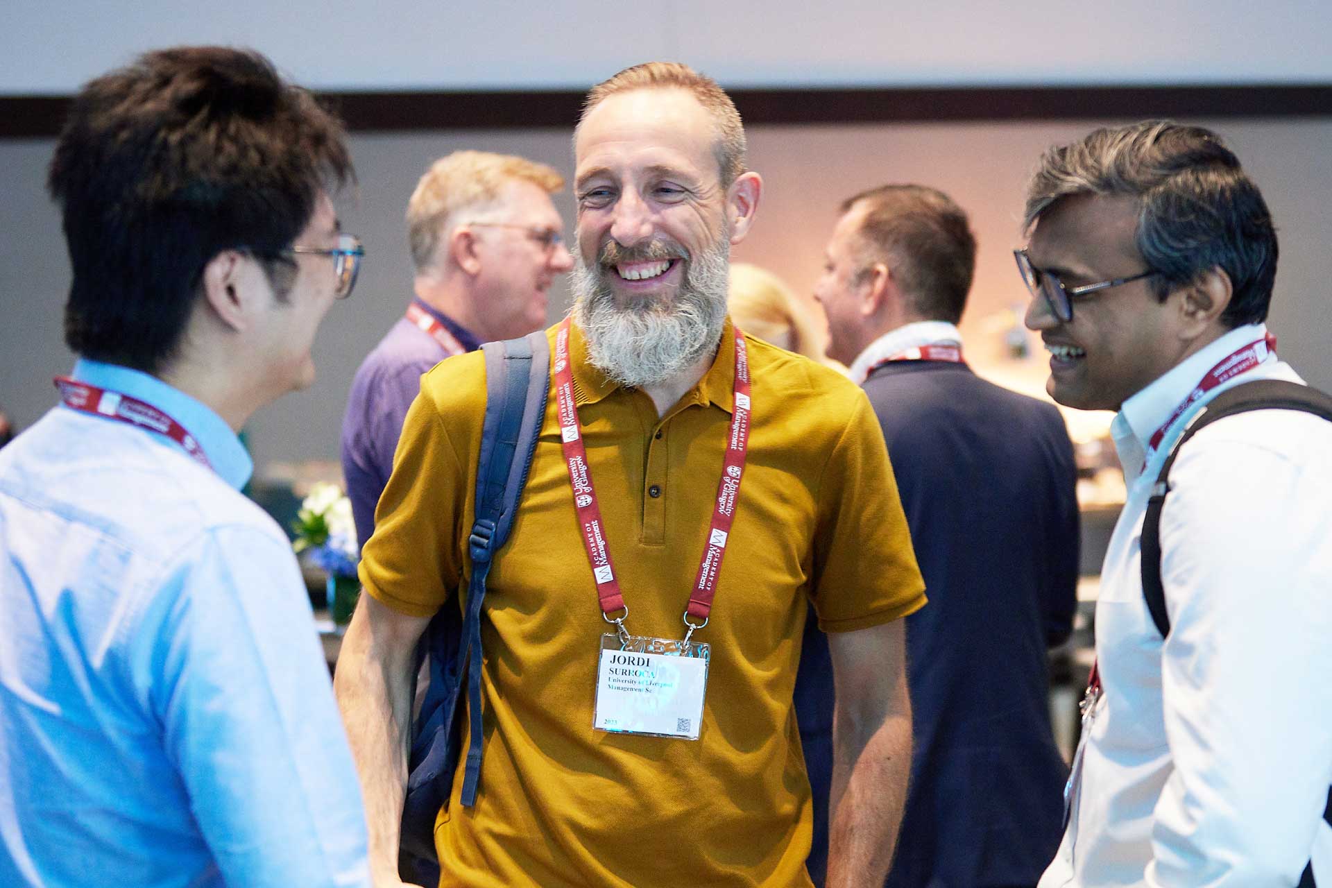 Three male academics enjoy a chat at the AOM 23 University of Liverpool reception.