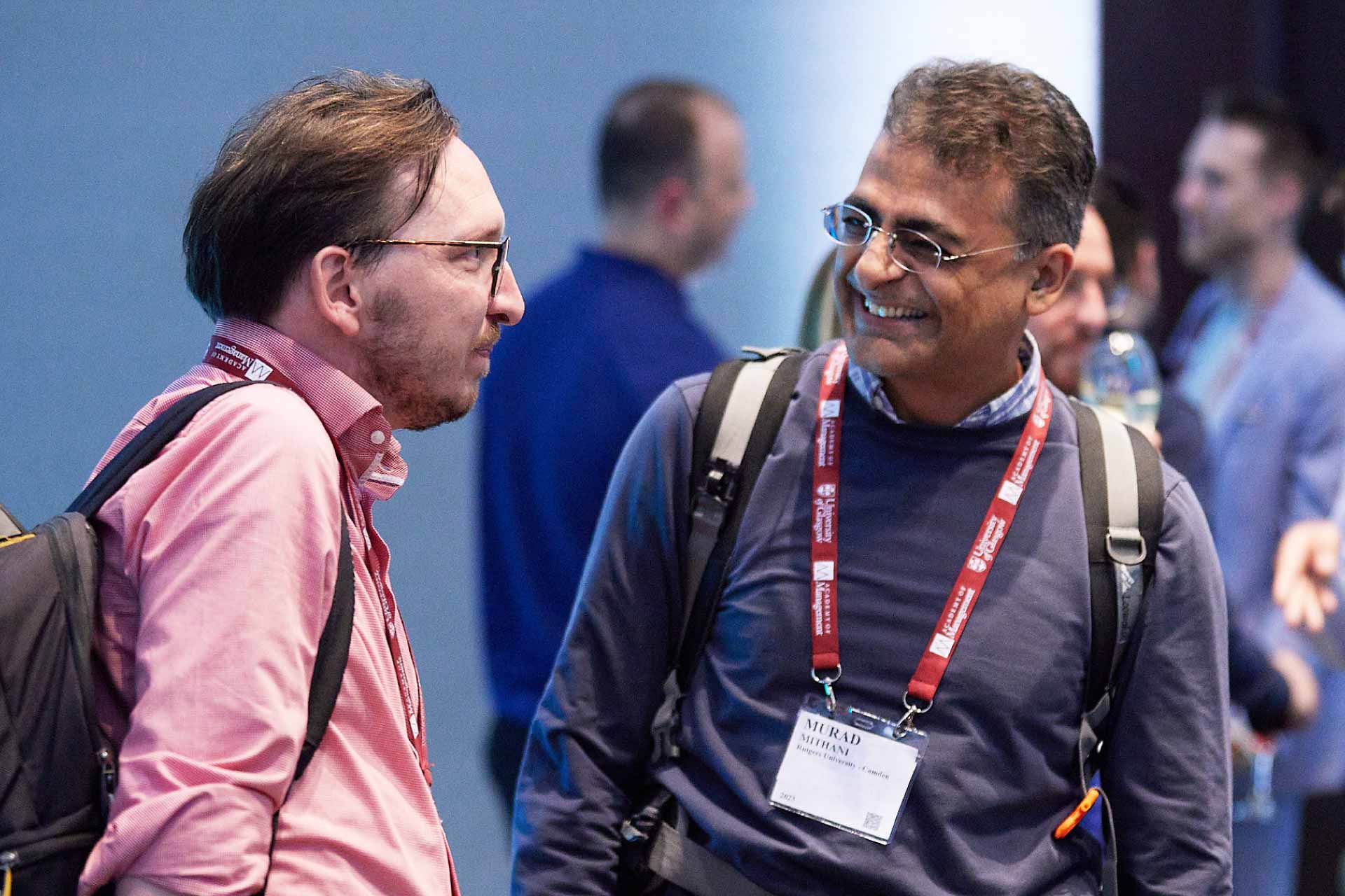 Two male academics talking at the AOM 23 University of Liverpool reception.
