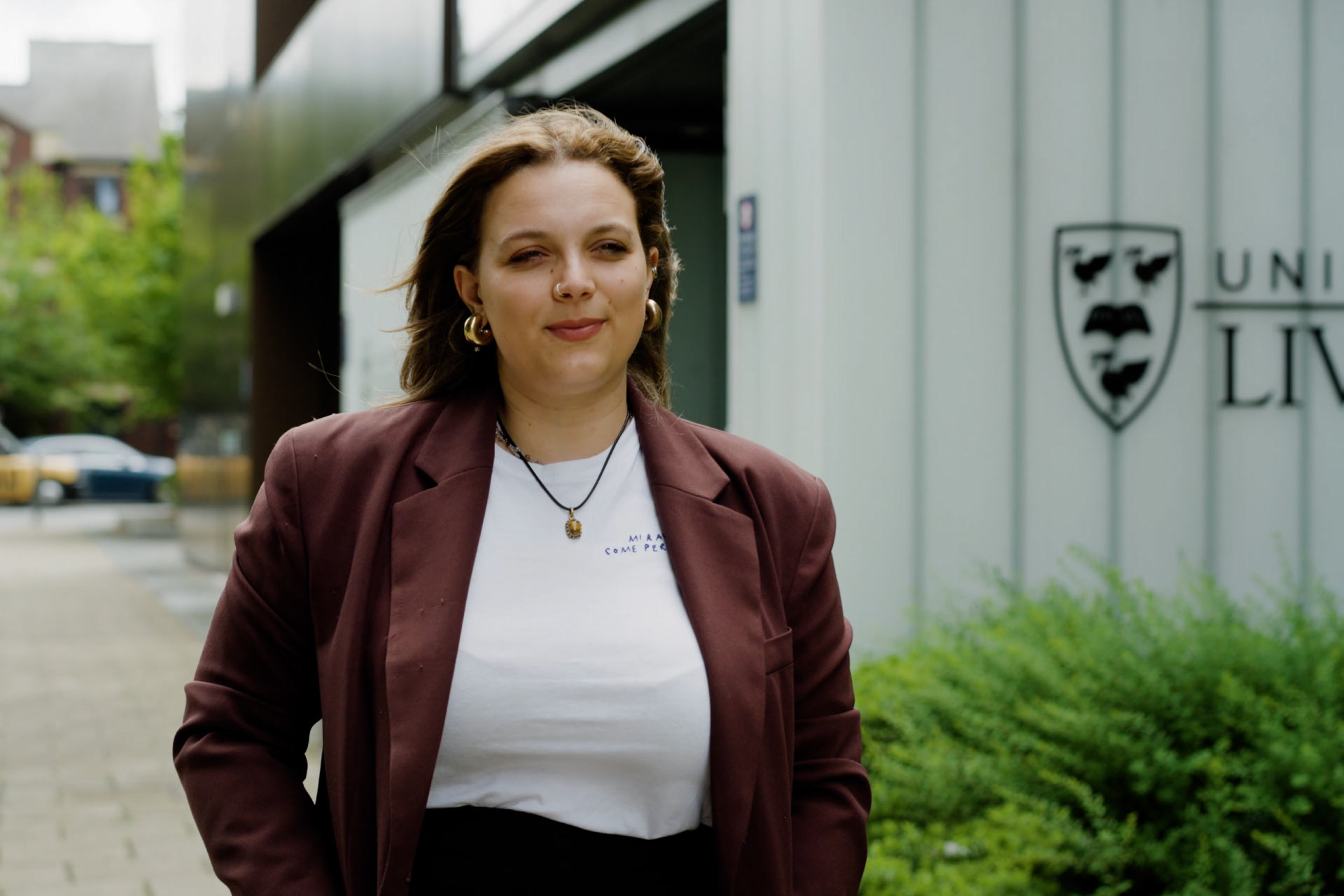Victoria Biagi walking in front of University of Liverpool Management School.