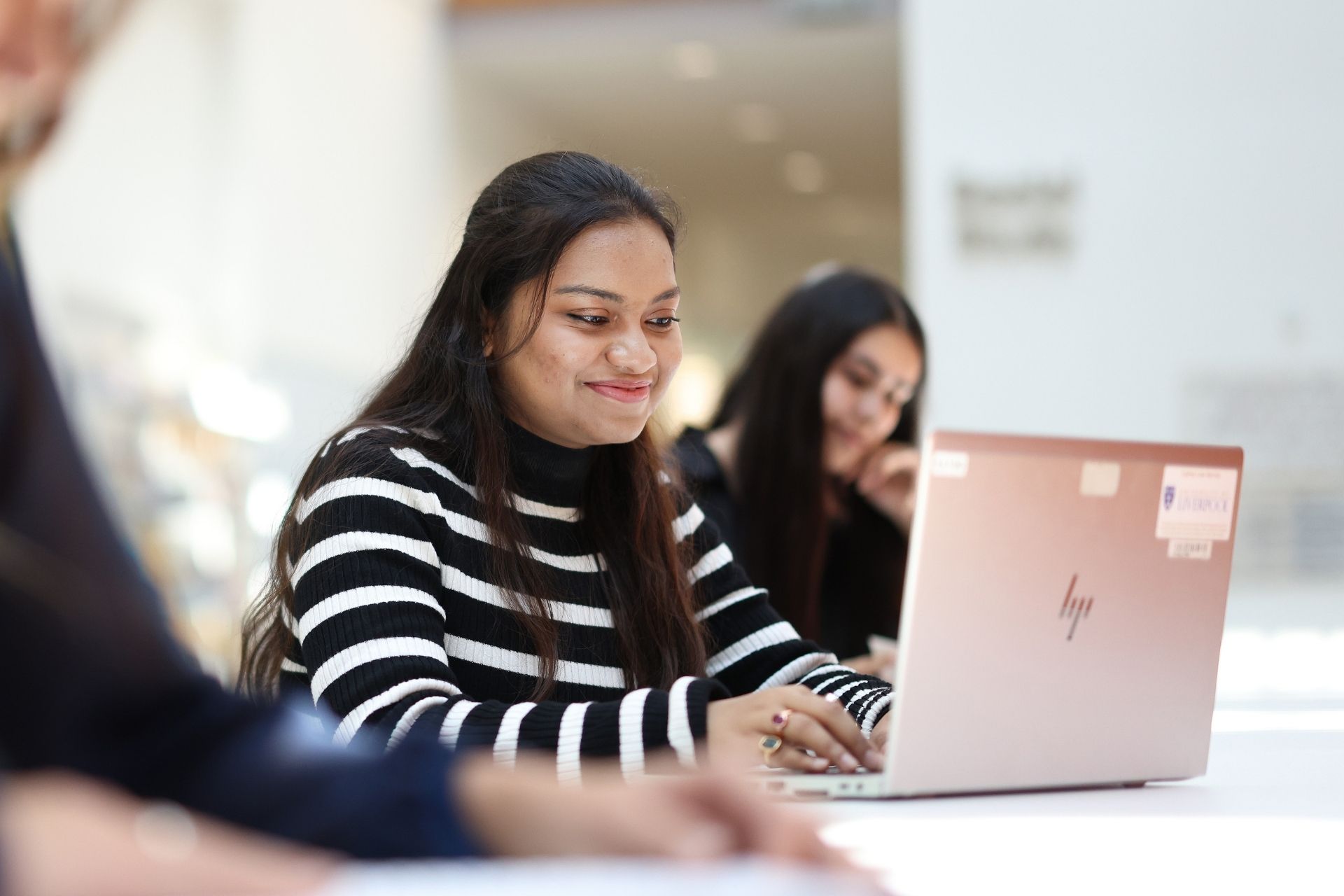 Female student using a laptop in university.