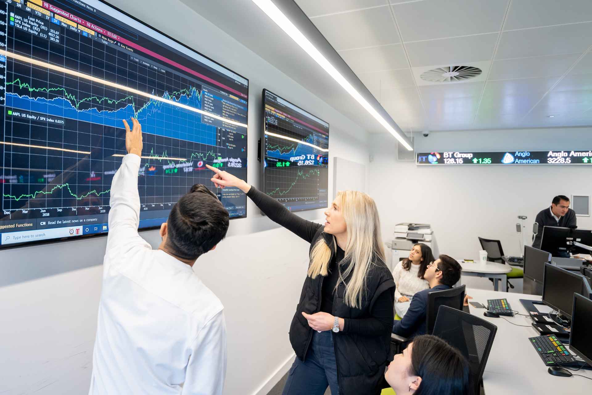 Students learning in the McKenzie Trading Suite using the Bloomberg Terminals
