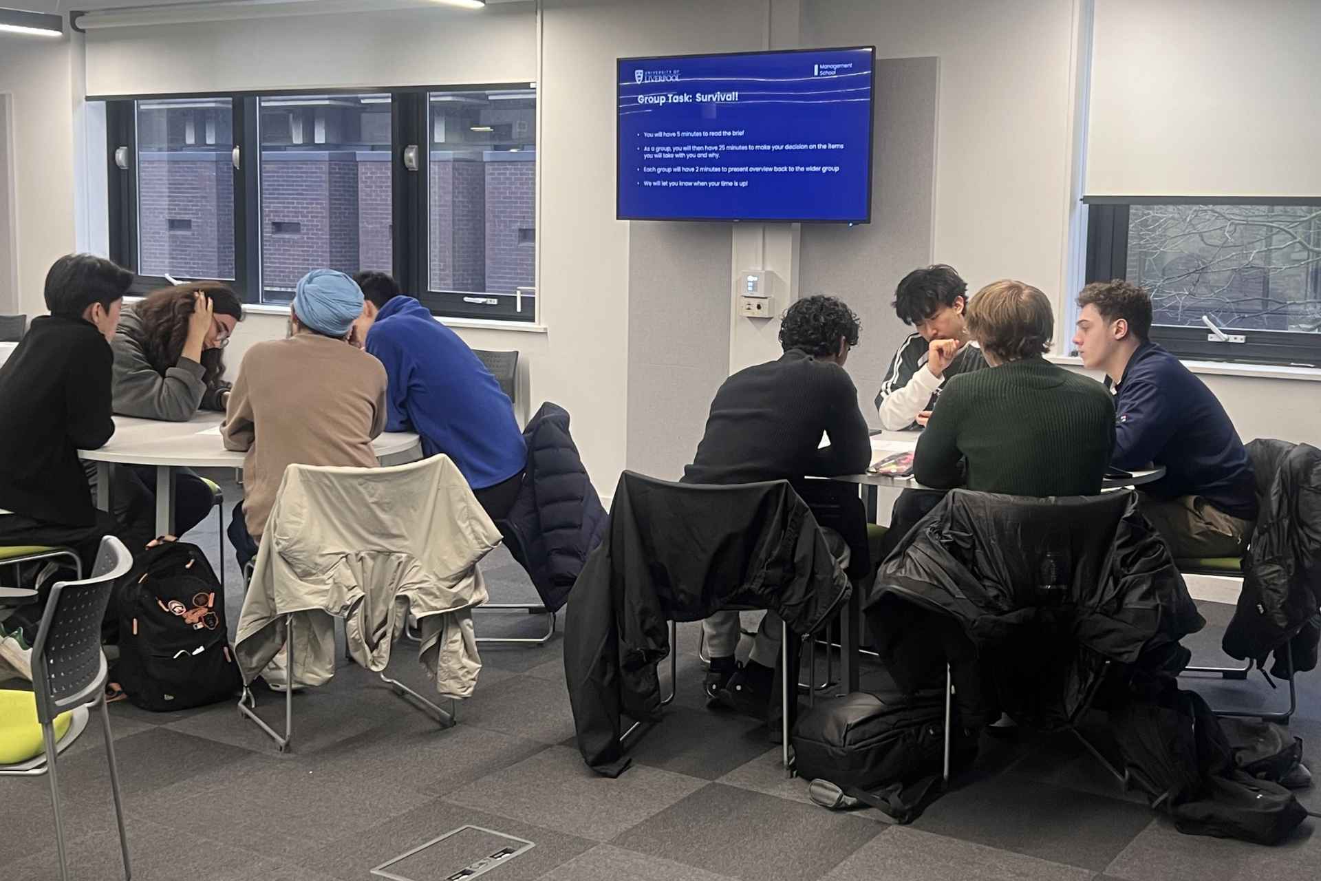 A picture Economics students at a mock assessment centre with Audit Wales