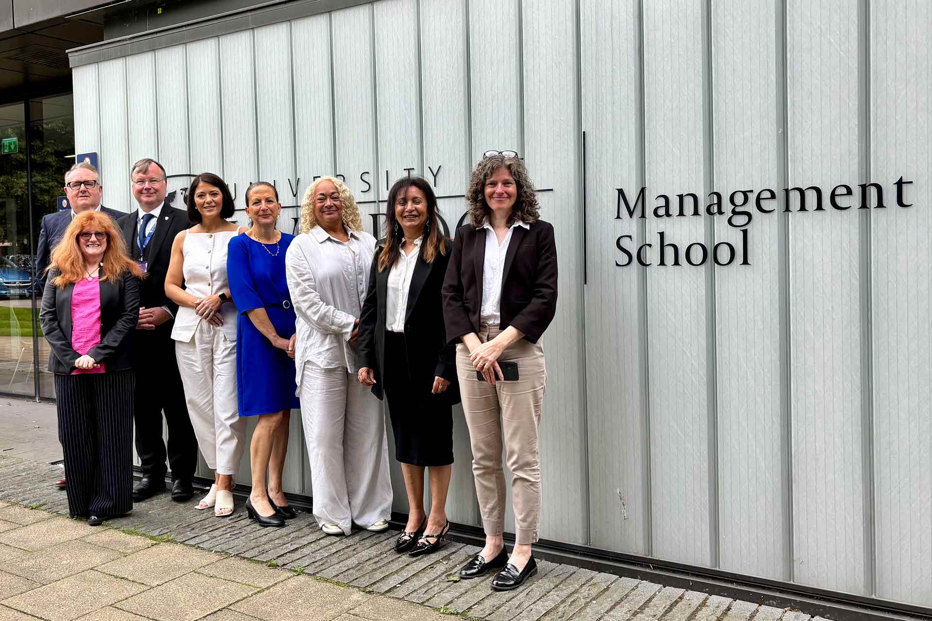 MP Kim Johnson with Liverpool colleagues standing in front of University of Liverpool Management School