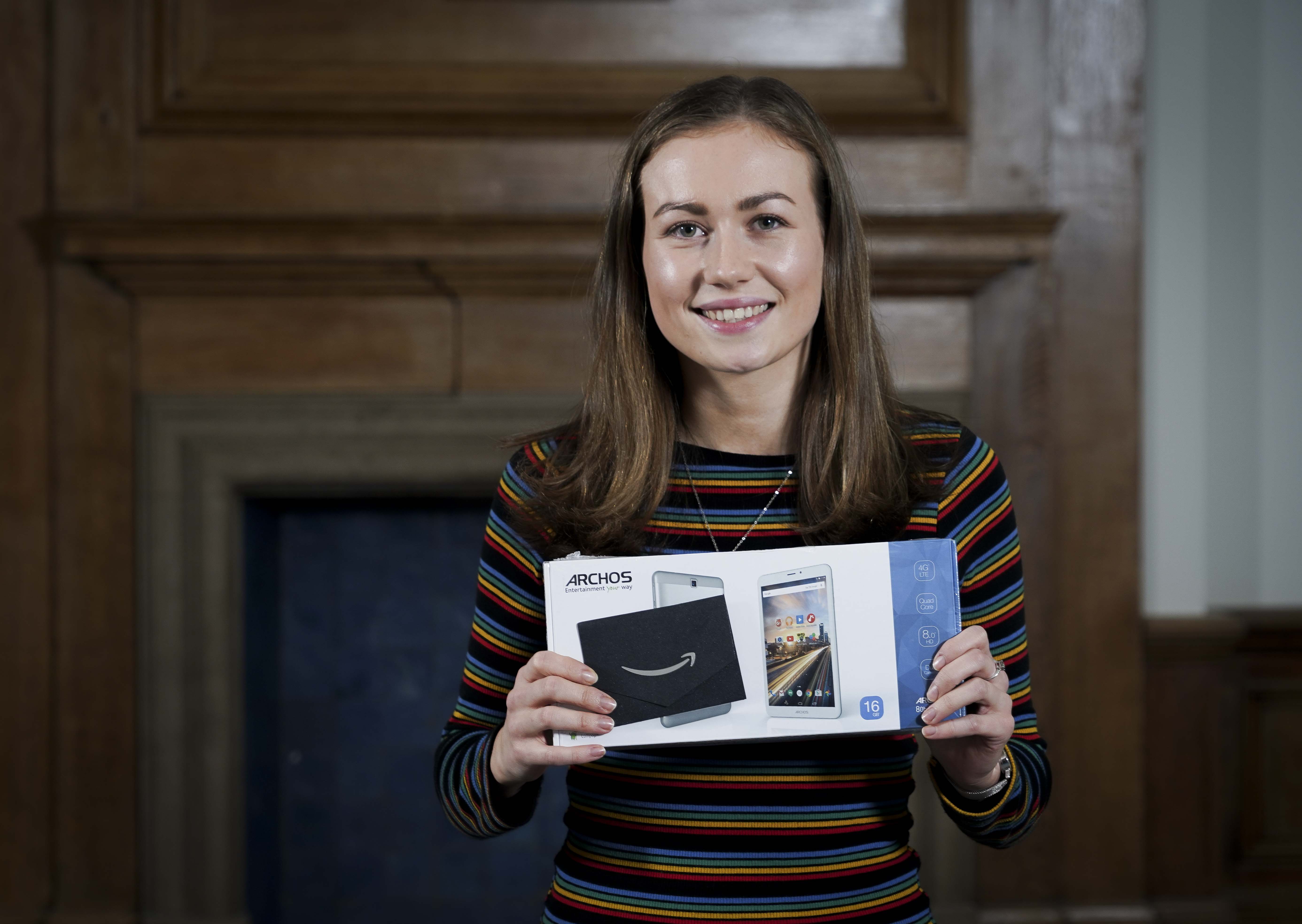 Alice holding her prize of a tablet and voucher as the winner of the 2018 EXPRESS competition