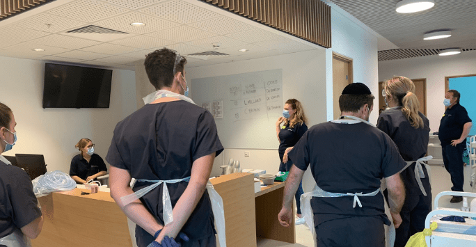 student doctors take part in a simulated clinical session