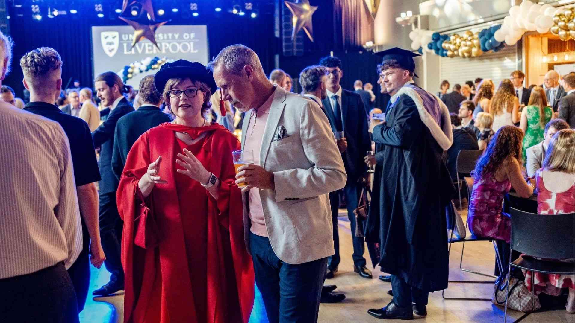 Dean of the School of Medicine, Professor Hazel Scott talking with a guest at the Graduation reception
