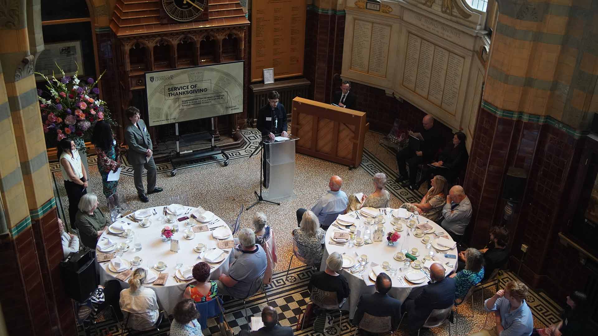 Students address the audience at the Service