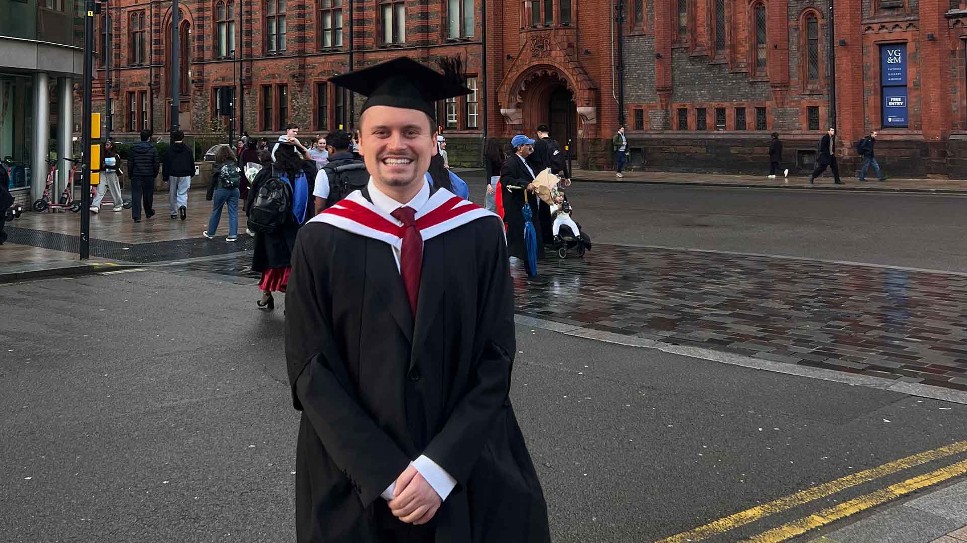 graduate in cap and gown at University Square