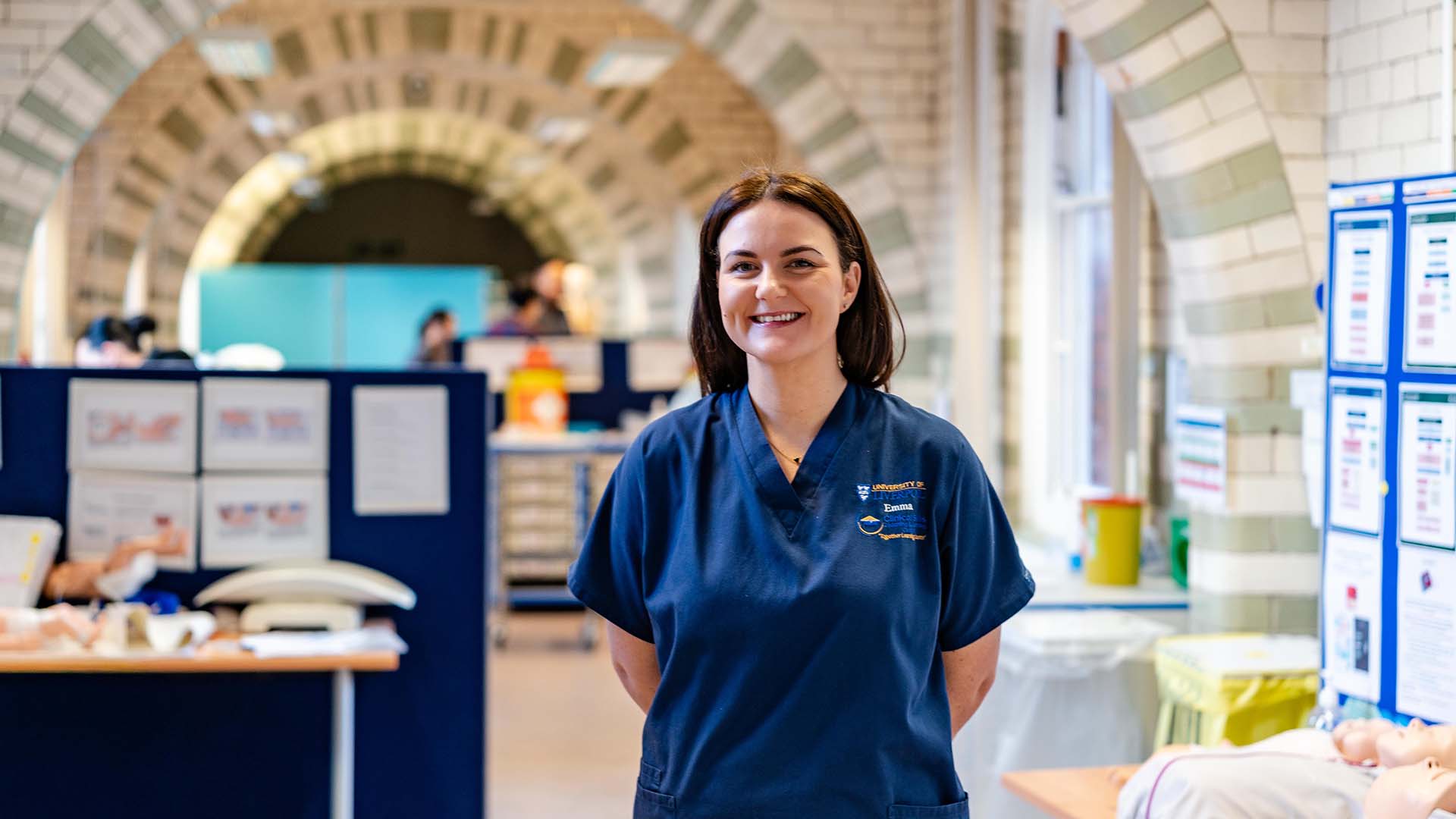 Clinical Skills Lecturer Emma McCabe in scrubs in the lab