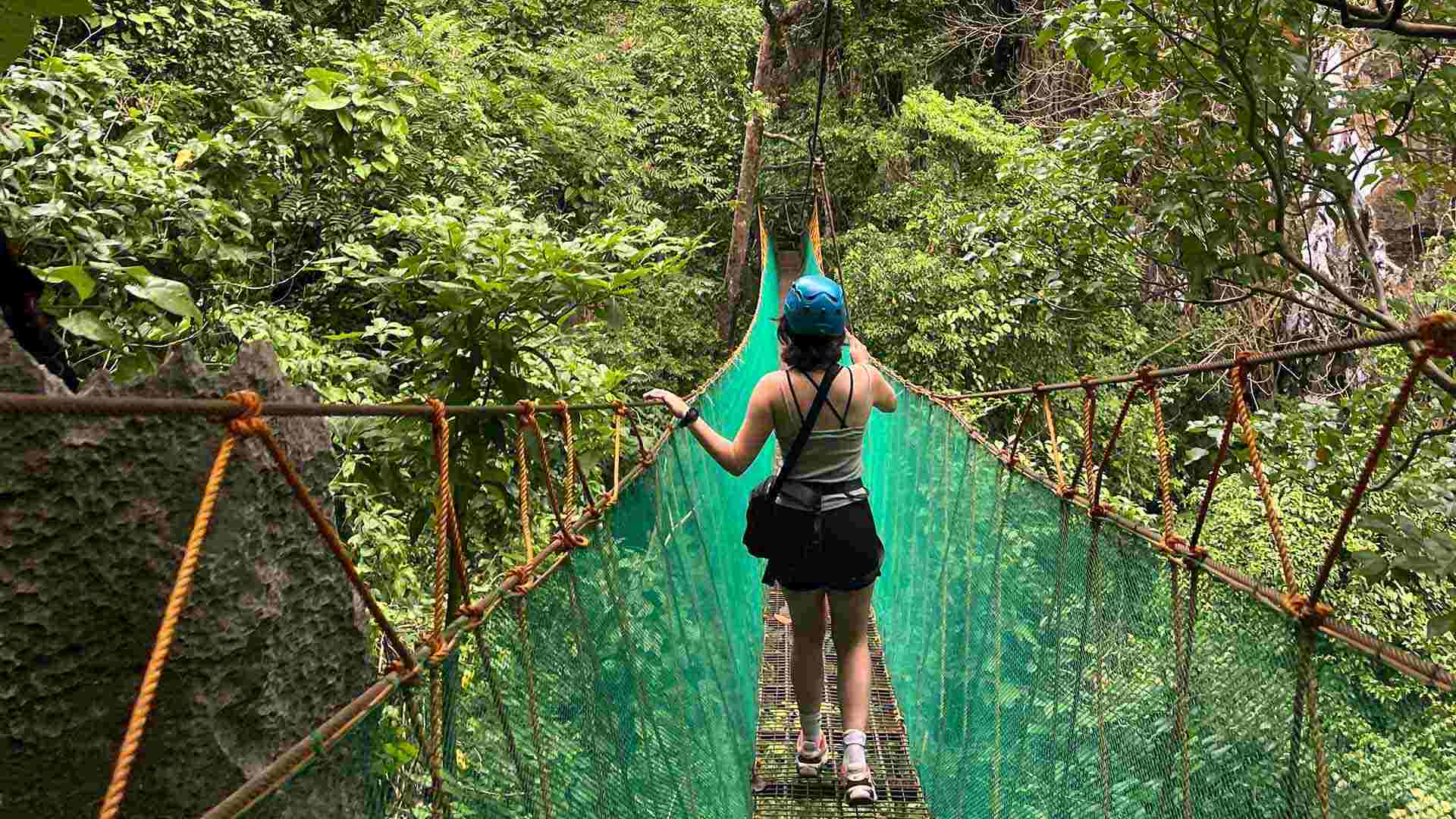 woman trekking through the rainforest in the Philippines on her medical elective
