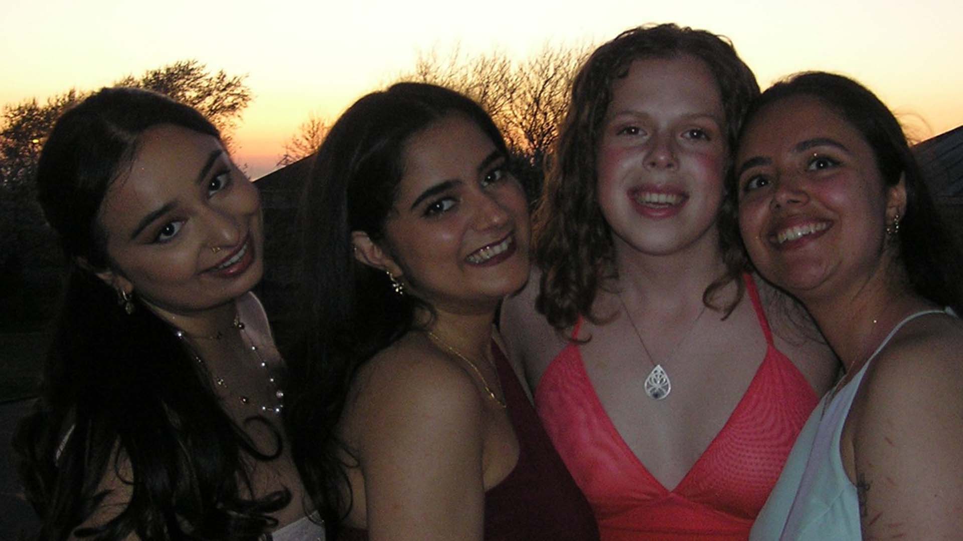 four women student doctors in formalwear at university ball