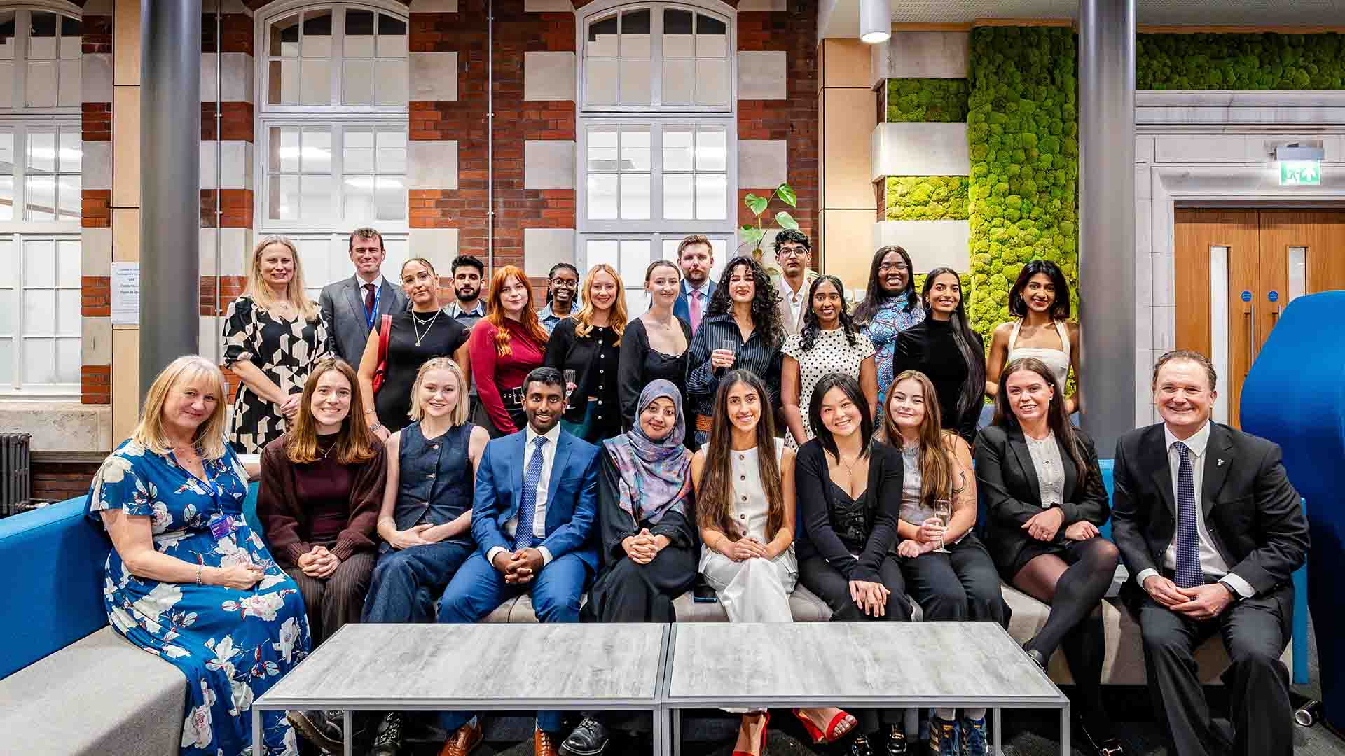 prize winners and leadership pose for a group photo at prize evening