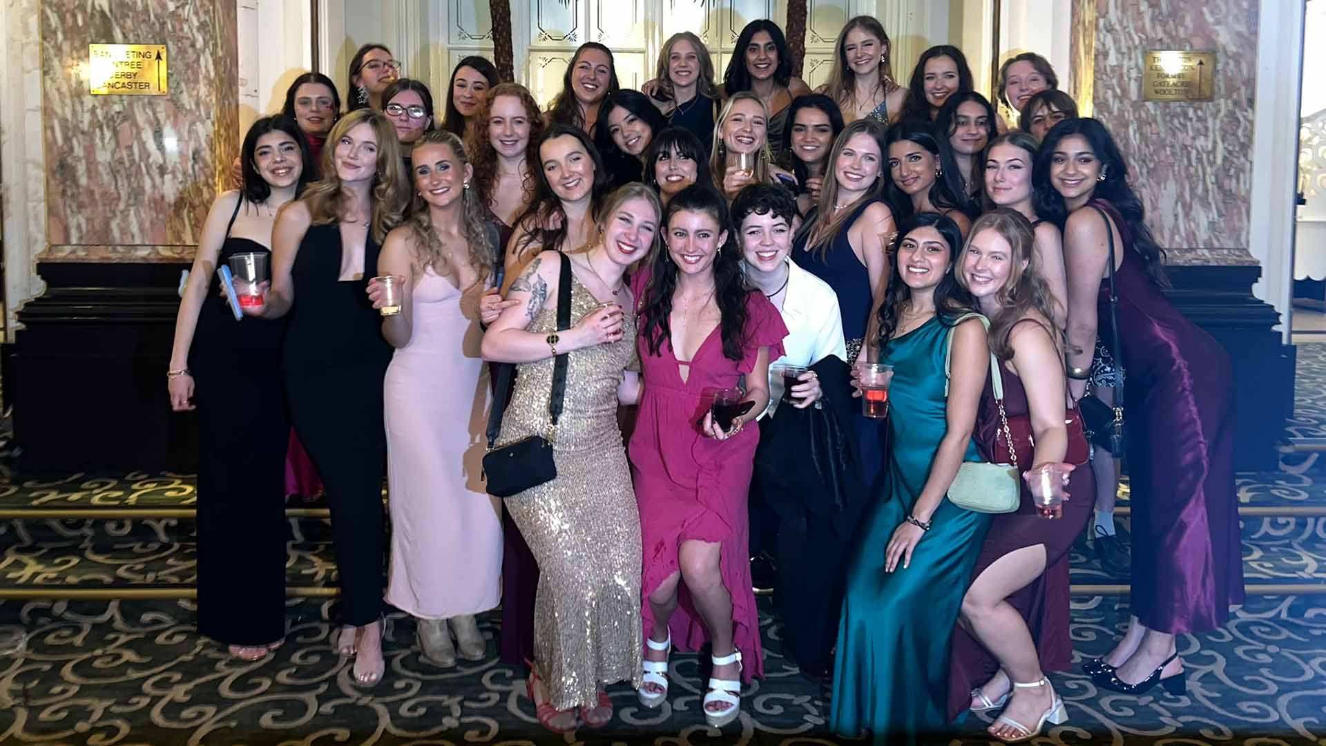 women in partywear attend a ball