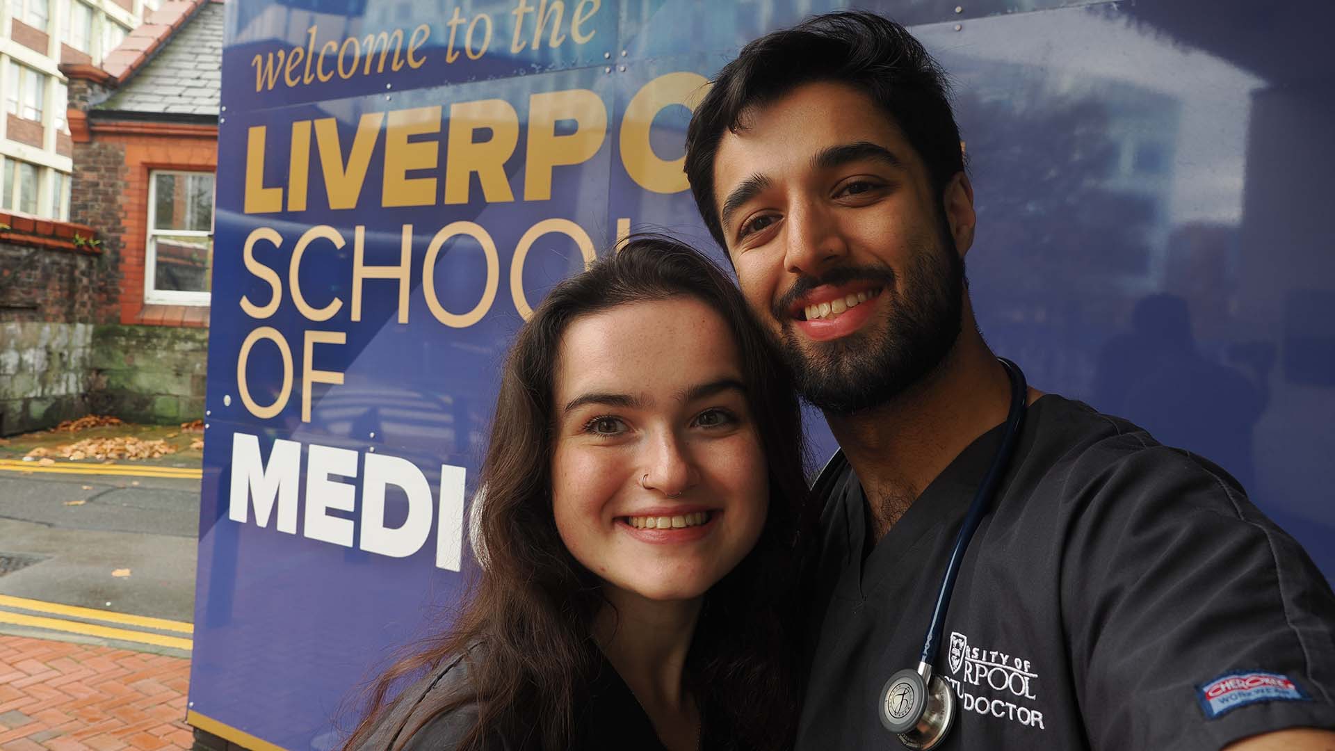 two student doctors at the entrance to Liverpool School of Medicine