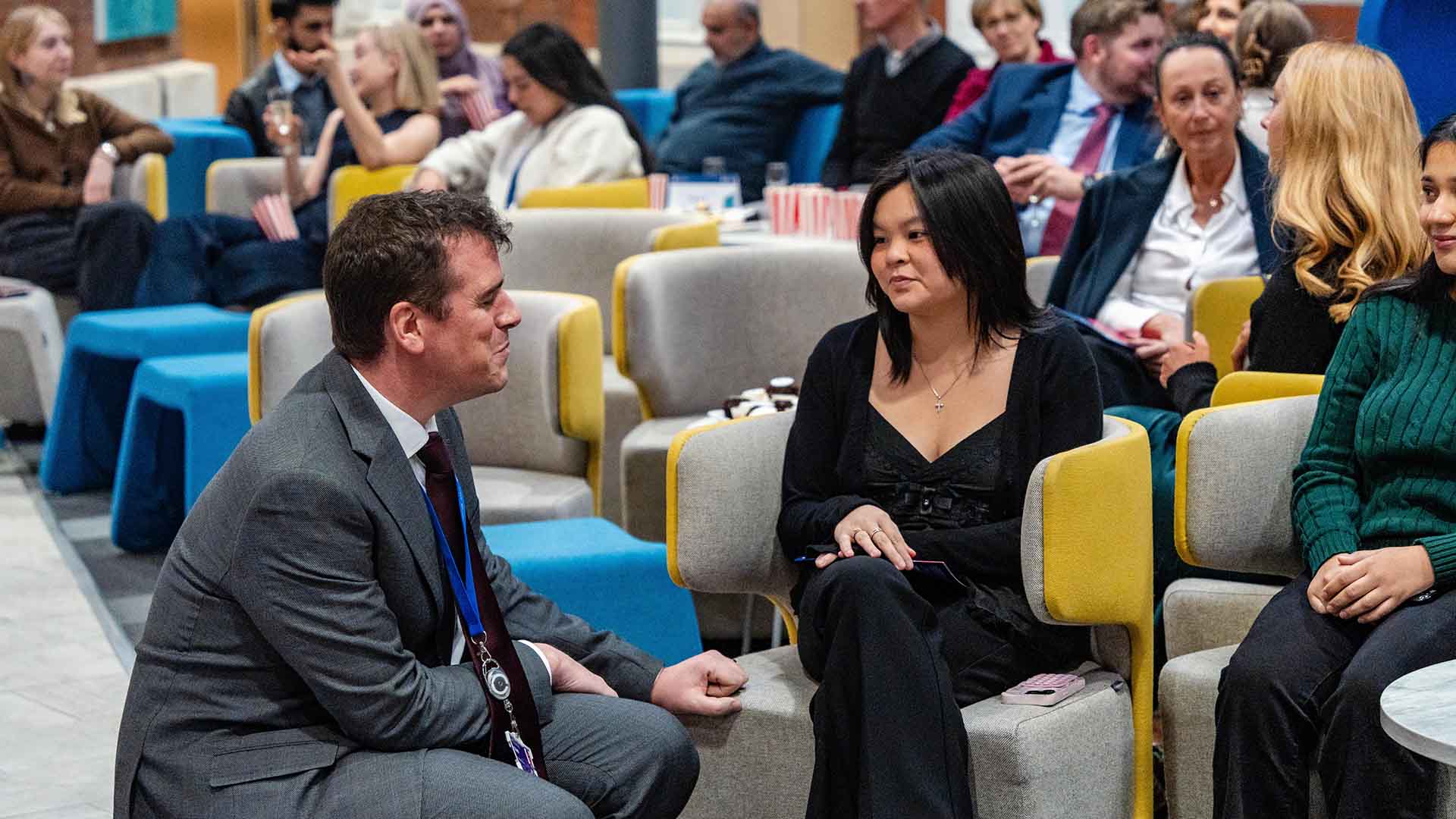 the Dean chats with a prize winner in the audience