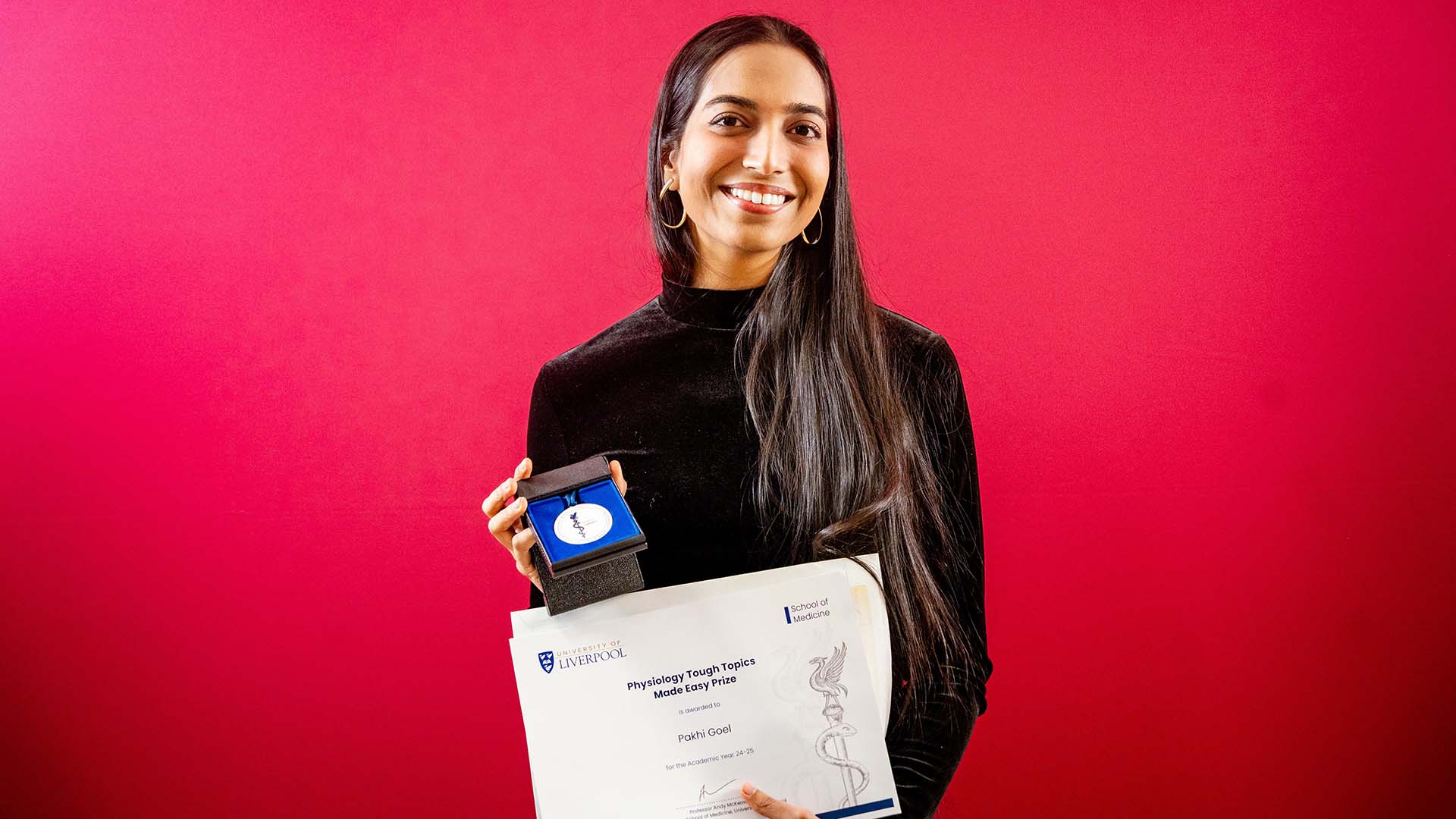 prize winning student with medal and certificate