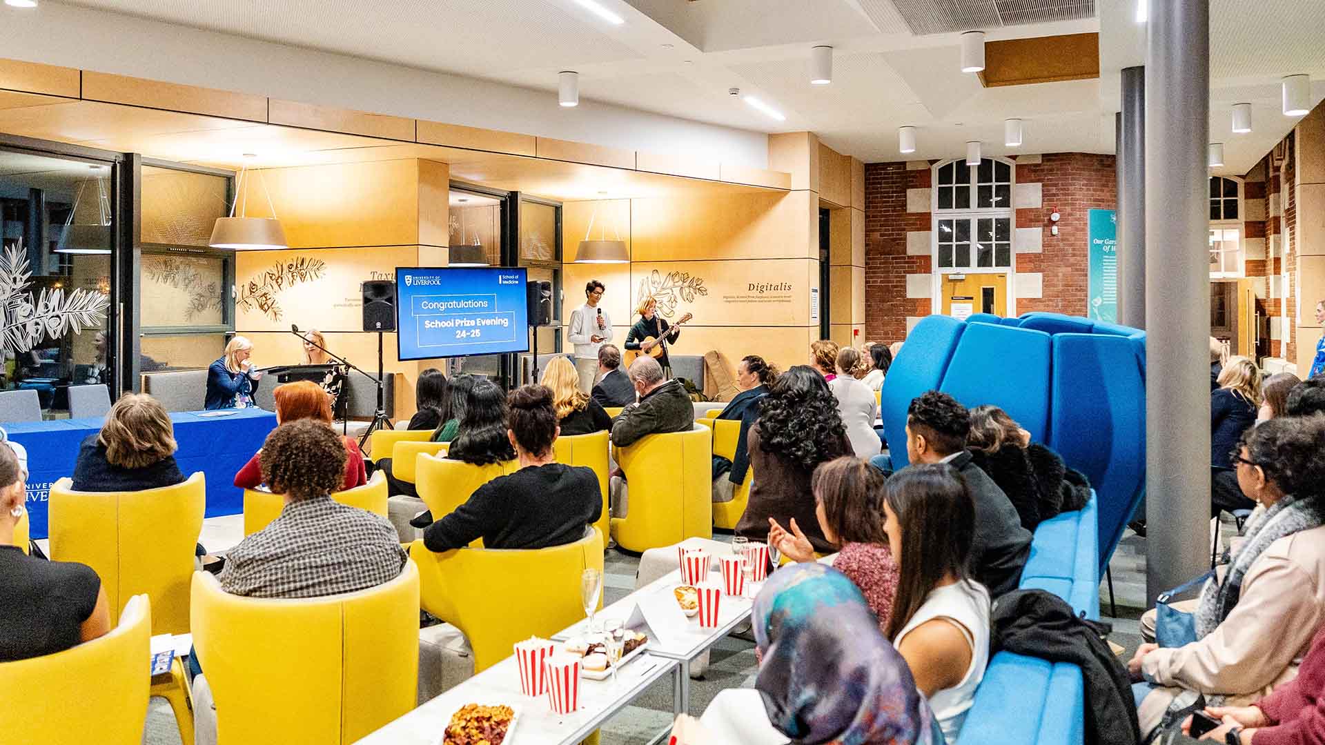 winner and special guests enjoying popcorn and snacks at prize evening