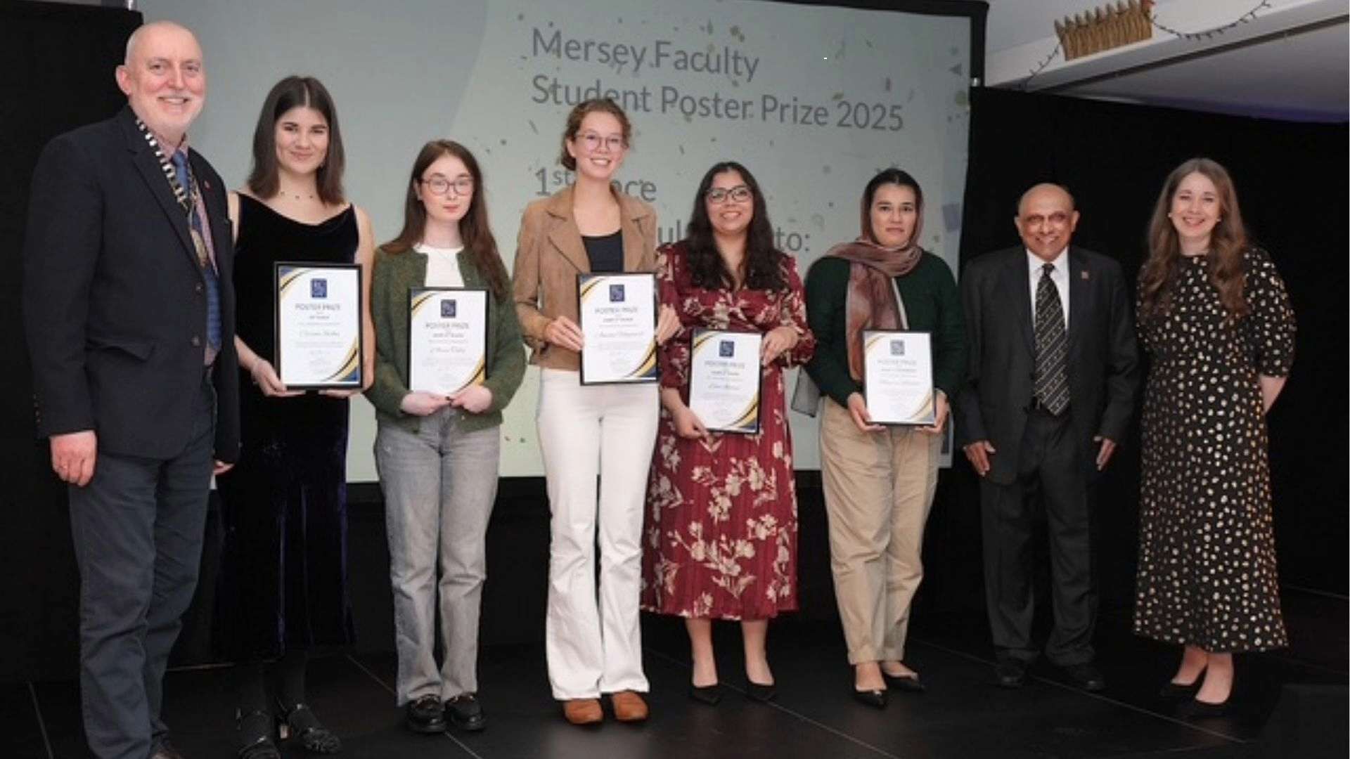 “Group of RCGP Mersey Faculty Poster Prize 2025 winners holding certificates on stage alongside two RCGP representatives