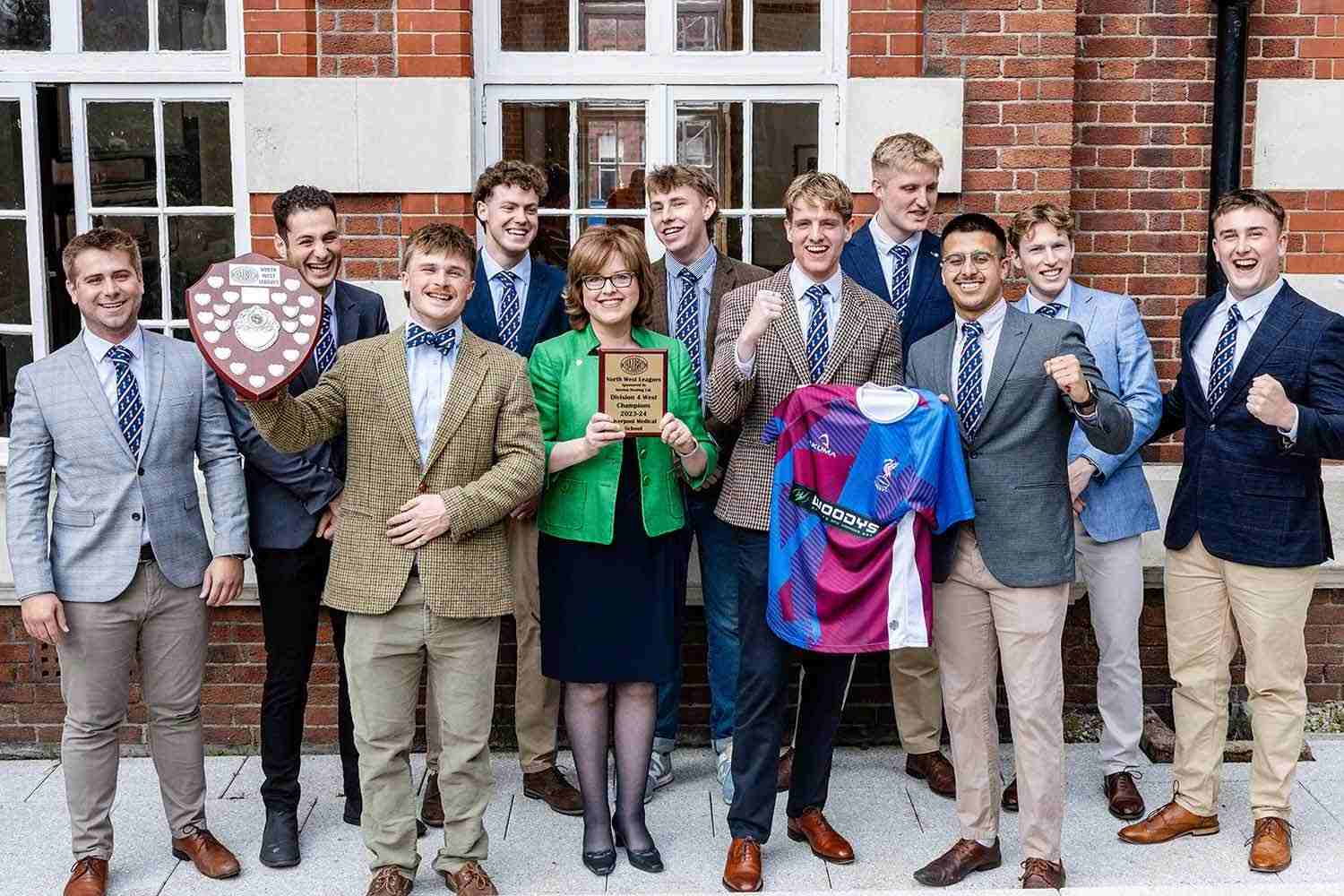 Players celebrate their league win with Professor Scott