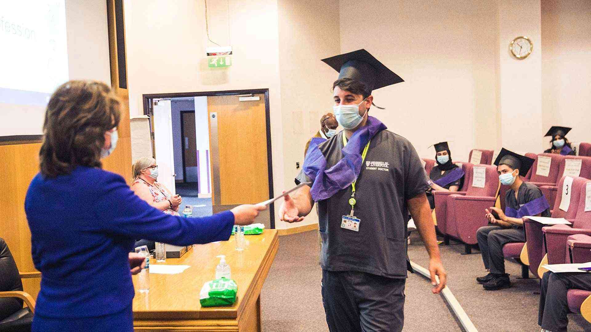 Professor Scott attends a socially distanced ceremony at an NHS trust to mark students' graduation during the pandemic