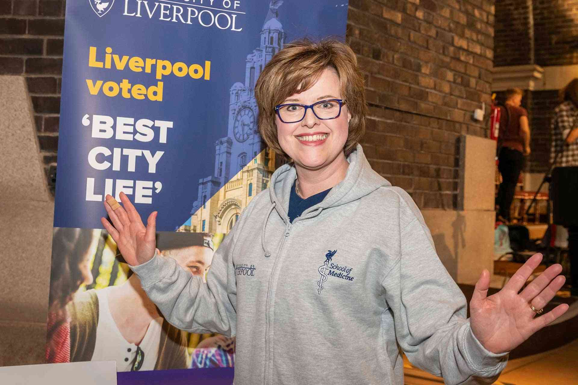 Professor Scott wears a School hoodie at student fair