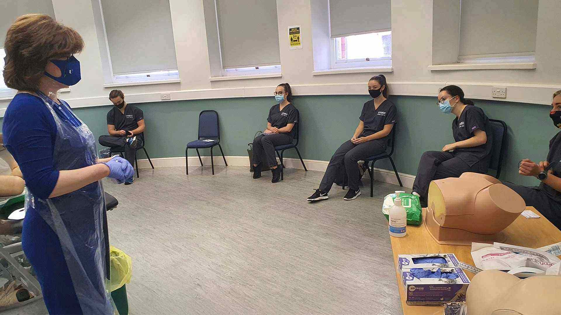 Professor Scott speaks with students at a socially distanced clinical teaching session during the pandemic