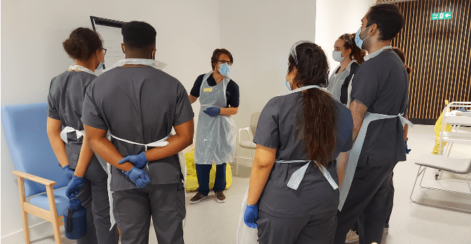 student doctors take part in a simulated clinical session