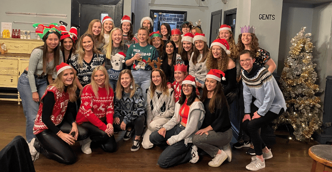 group of women wearing festive jumpers