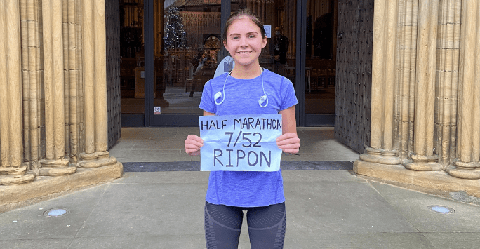marathon runner holding sign