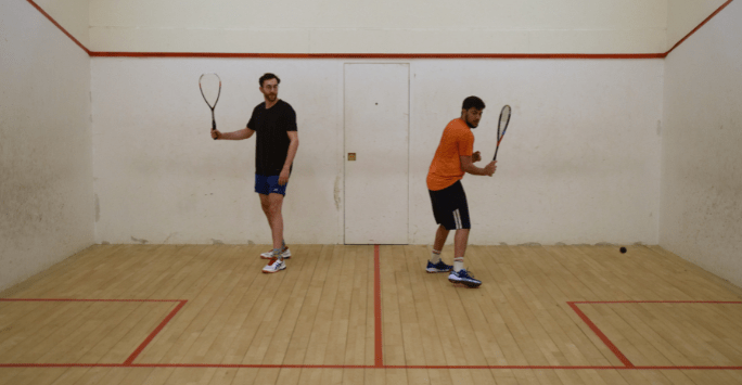 2 people play squash