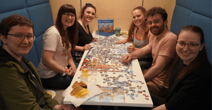 students work together on a jigsaw puzzle