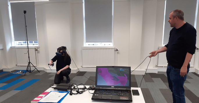 a woman interacts with a virtual reality dog