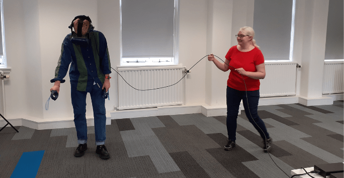 students interact with virtual reality dogs