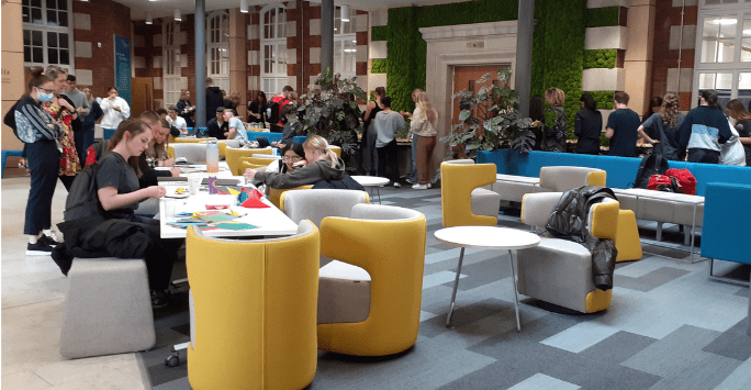 students hang out in a communal hub space