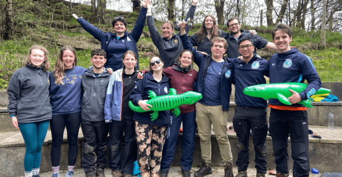Students pose with inflatable crocodiles