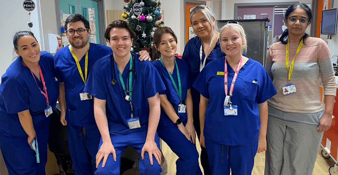 Team of doctors in scrubs on the ward at Warrington Hospital