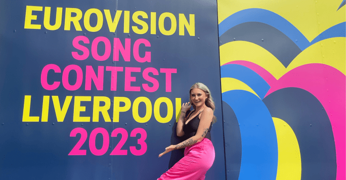 woman poses at Eurovision sign