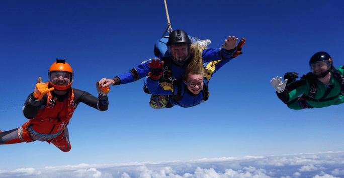 skydivers in colourful jumpsuits in freefall