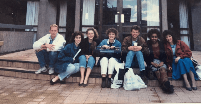 group of friends on steps in 1980s