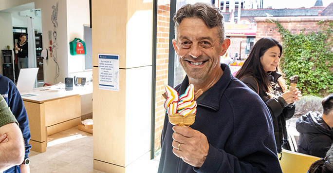 Lecturer smiles with ice cream