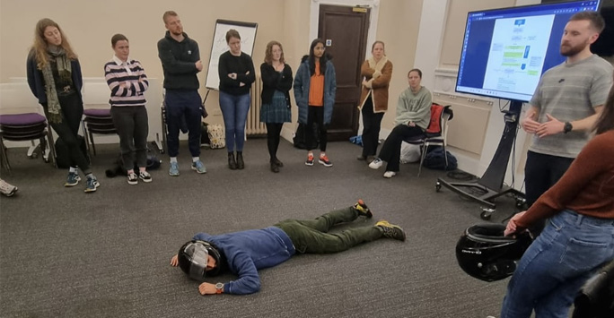 Student lying on the floor demonstrating rescue techniques for trauma medicine