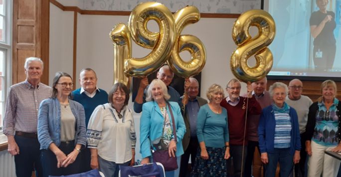 Alumni group with '1968' balloons
